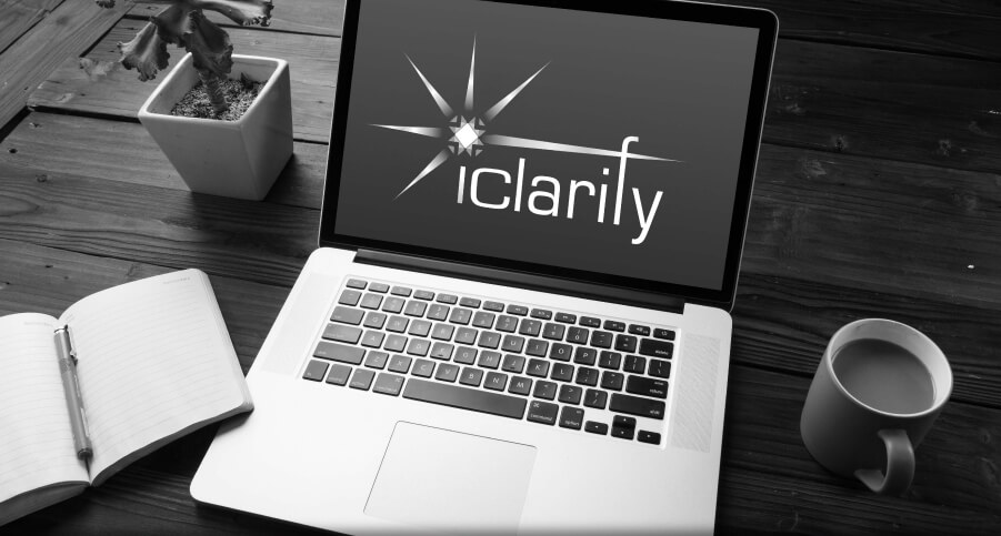 iClarify seminar on a desktop with laptop and notebook